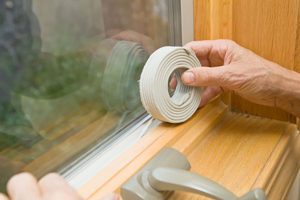 inspecting weather stripping on windows and doors for fall